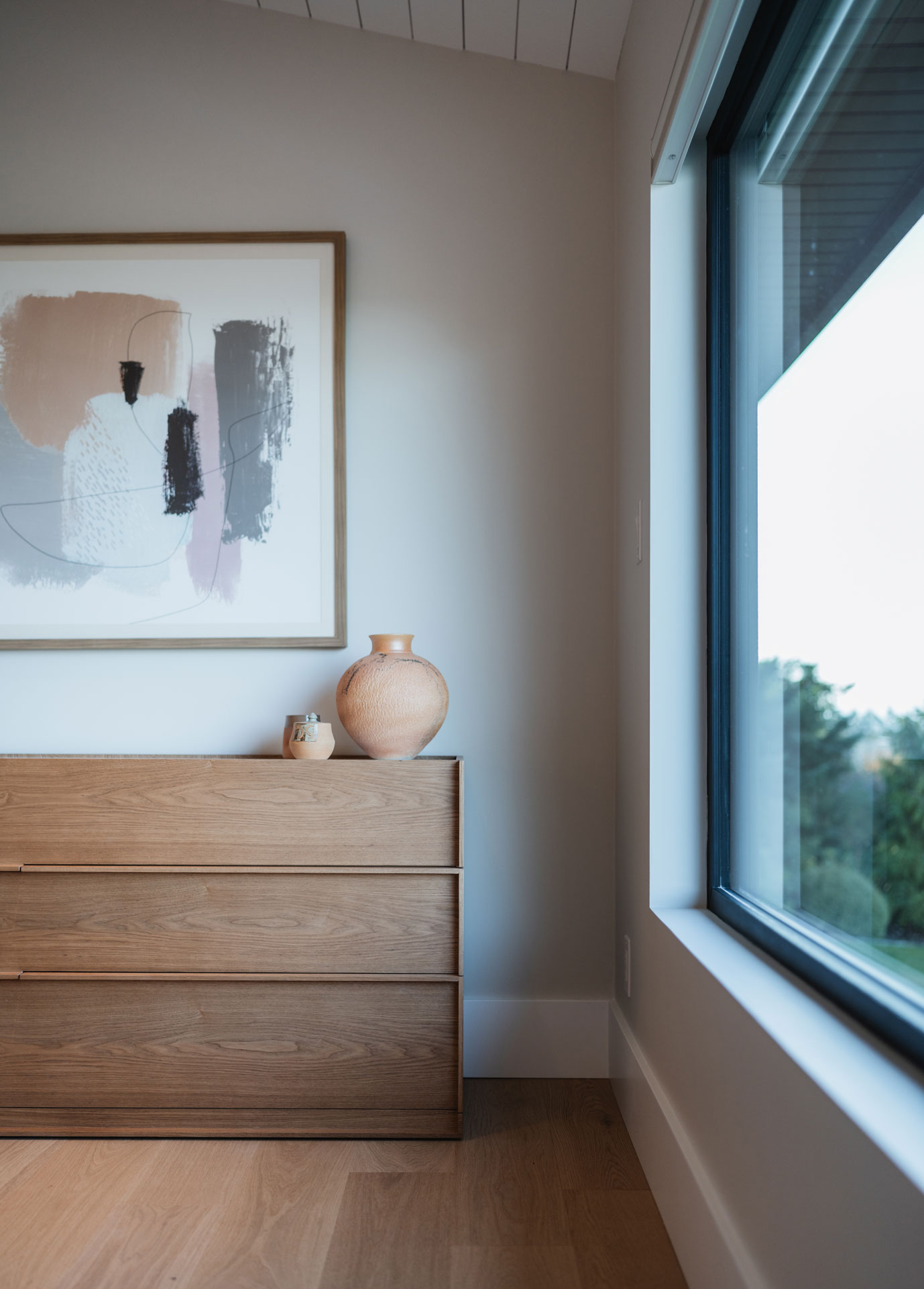 Modern bedroom with clean lines and abstract artwork