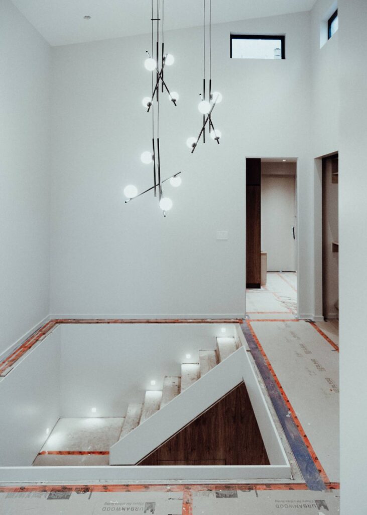 Indoor view of house under construction with lamp attached to ceiling