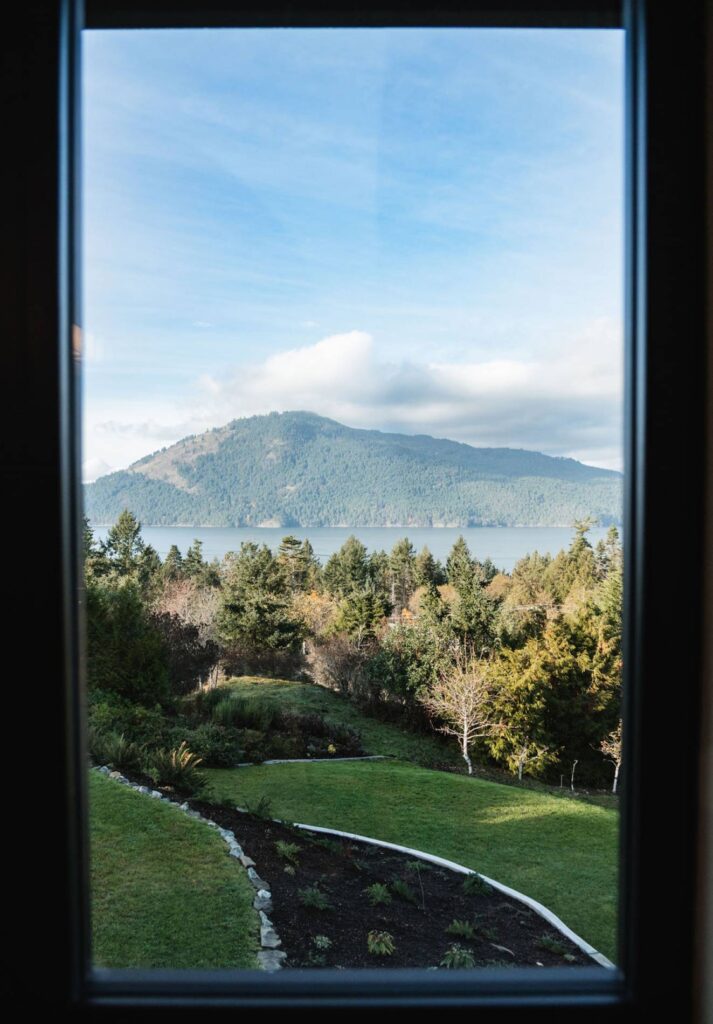 View outside of window looking at water and mountain