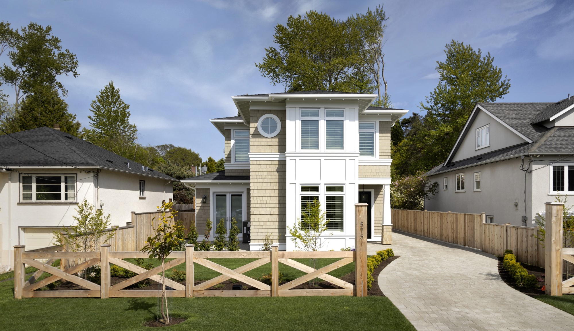 Custom home with white and beige siding built by Fayzebuilt