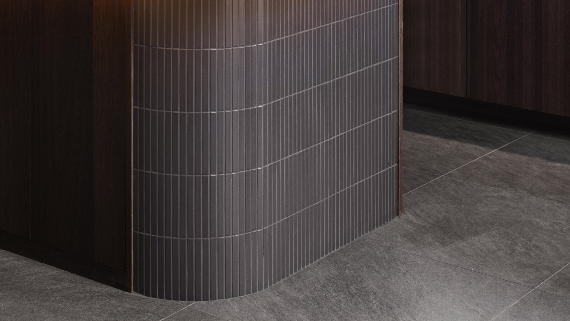 intricate dark tiles work on modern kitchen island